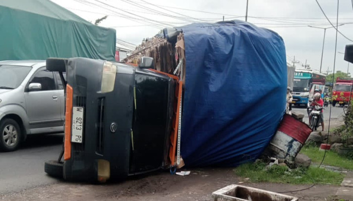 Akibat Muatan Berlebih, Pick Up Terguling Di Raya Gilang Taman